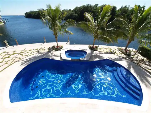 Mosaic glass pool with intricate design, overlooking Naples Bay, created by Mosaiclegs Art Studio.
