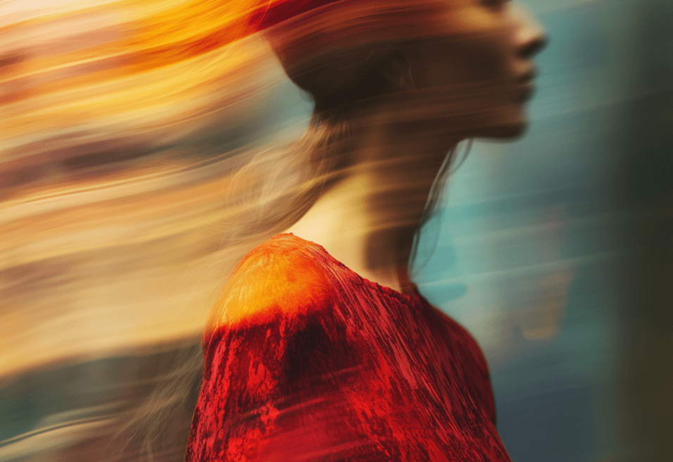 A woman in a flowing red dress is captured mid-motion, exuding elegance and energy.