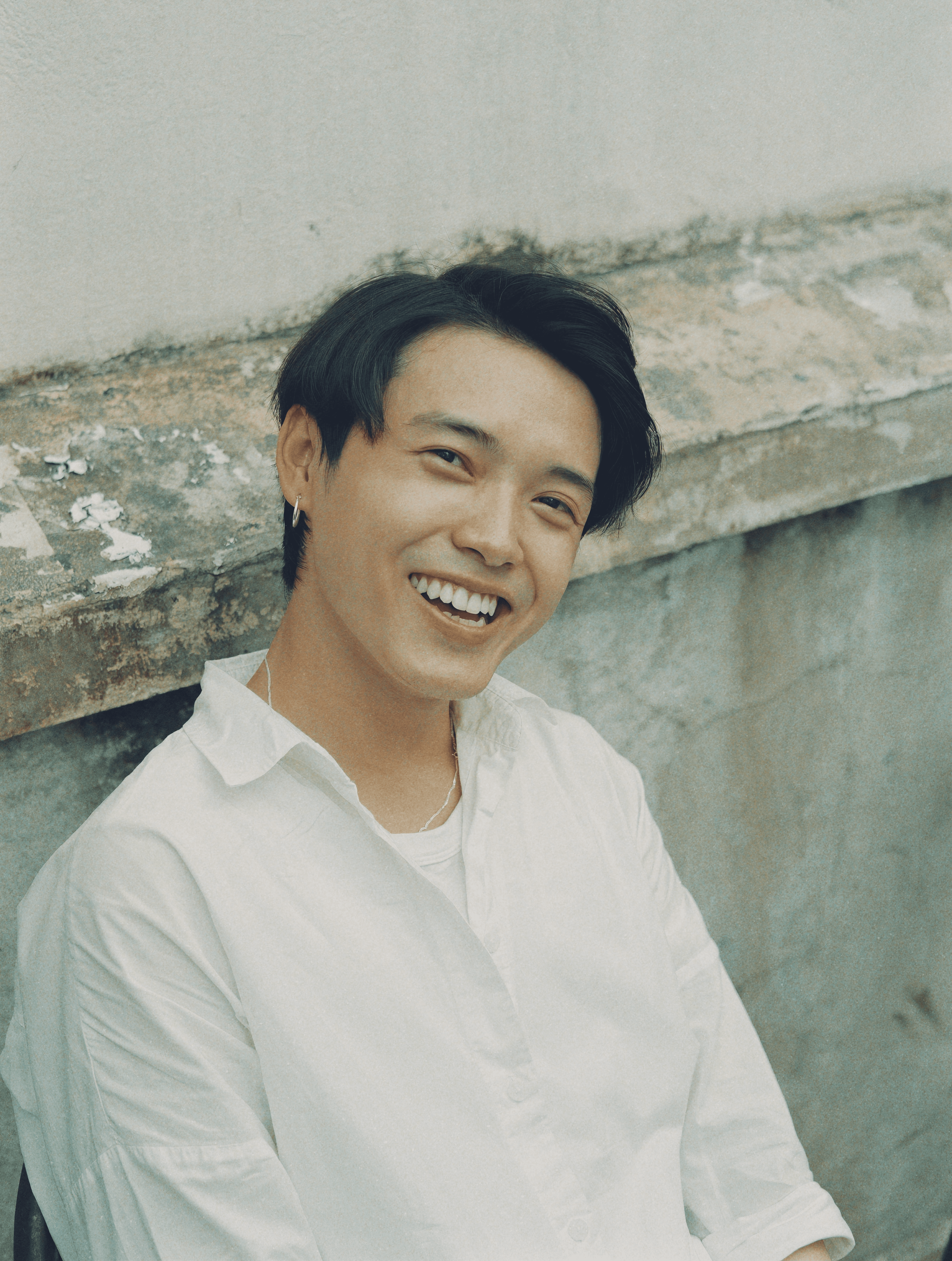 woman in white button up shirt smiling