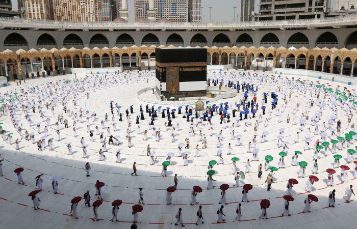 Stone kitchen with cabinets, exposed beam ceiling, terracotta floors.