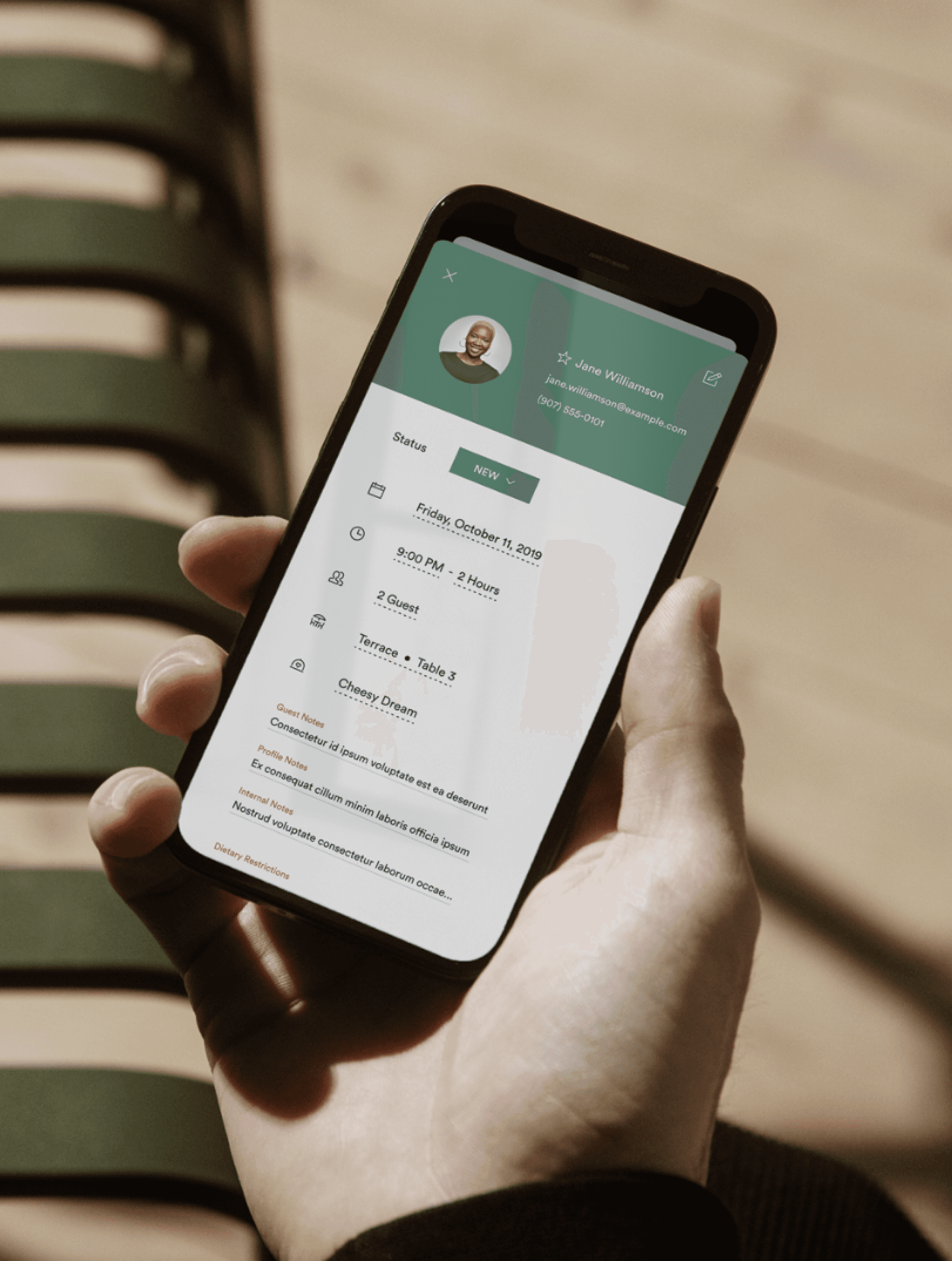 iphone on hand with profile open restaurant booking system design
