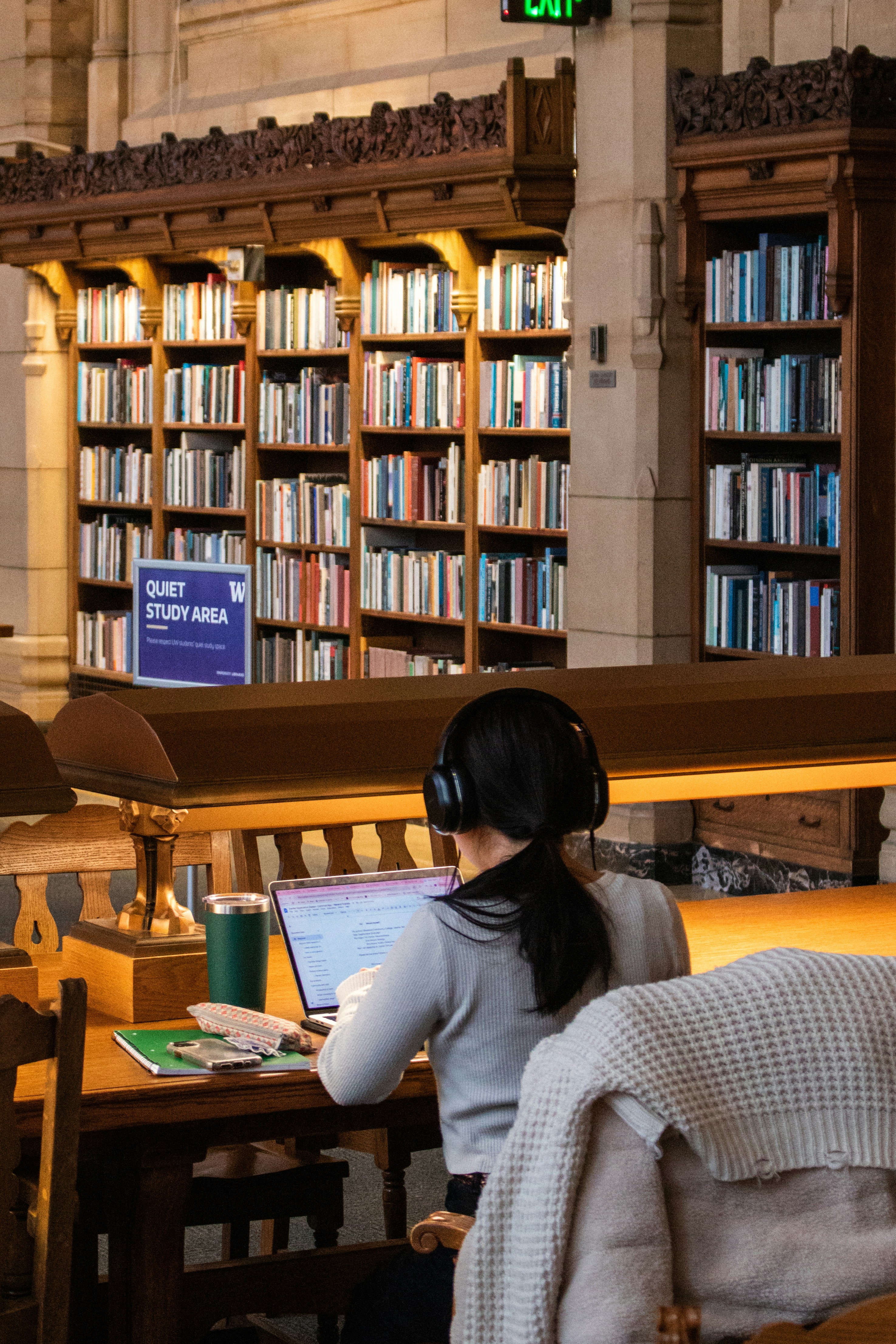 Woman studies in a quiet library study area.