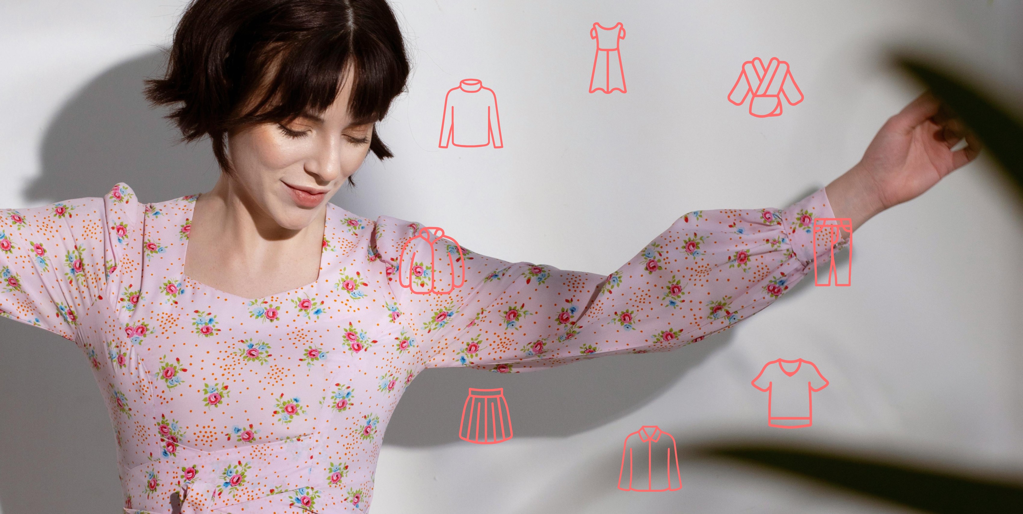 smiling womn holding a pink shirt