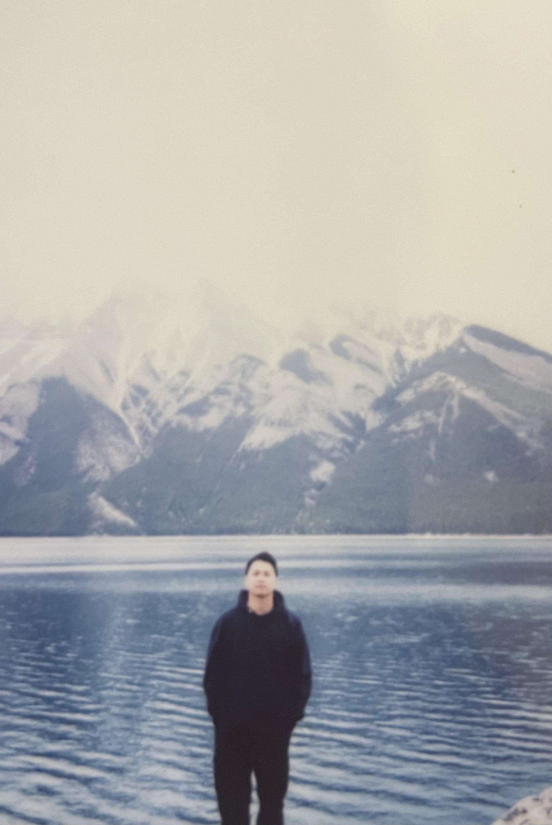 A view of a studio interior with modern decor, featuring large windows that offer a glimpse of lush greenery outside