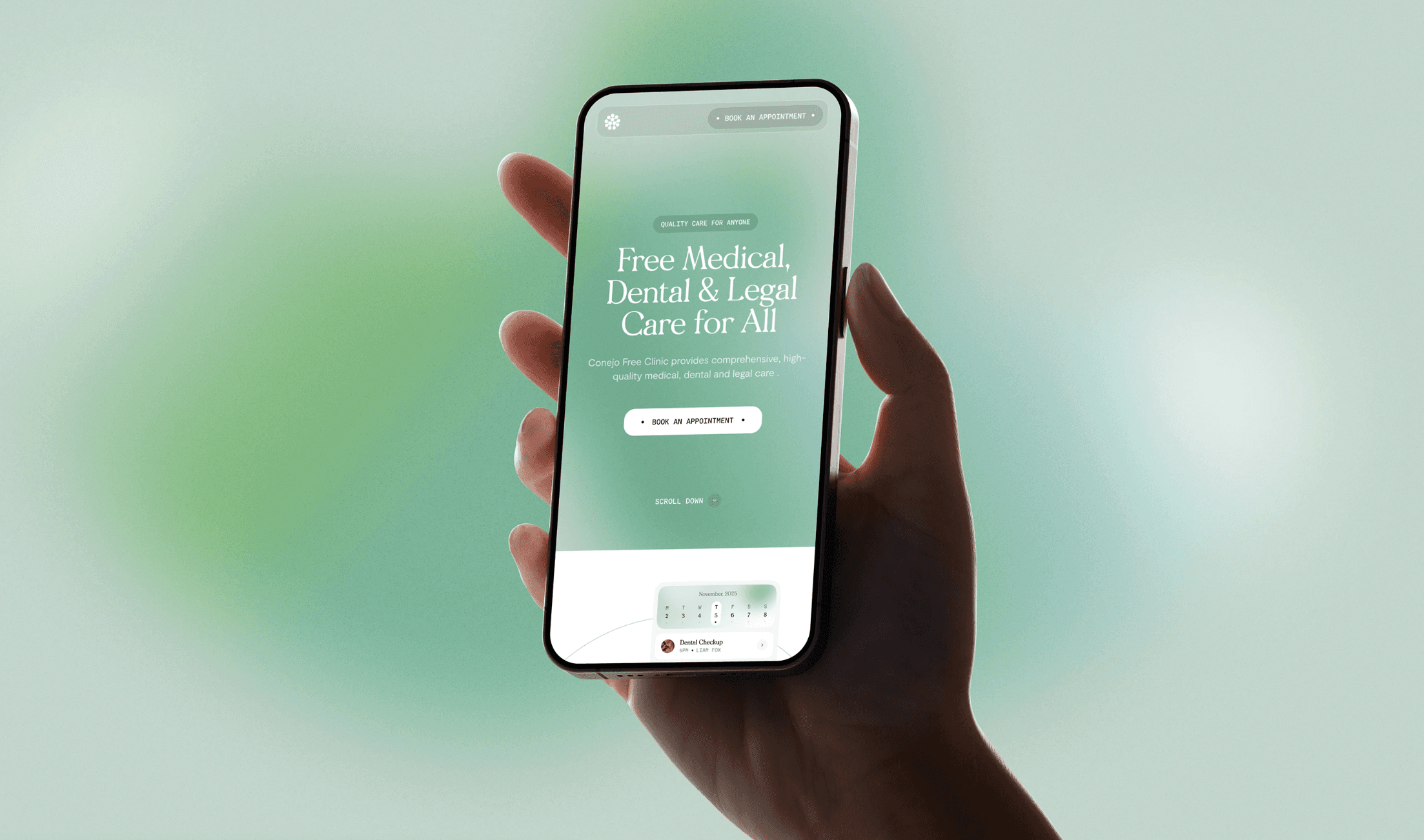A young person with curly hair smiles at the camera while sitting in front of a laptop against a dark background.