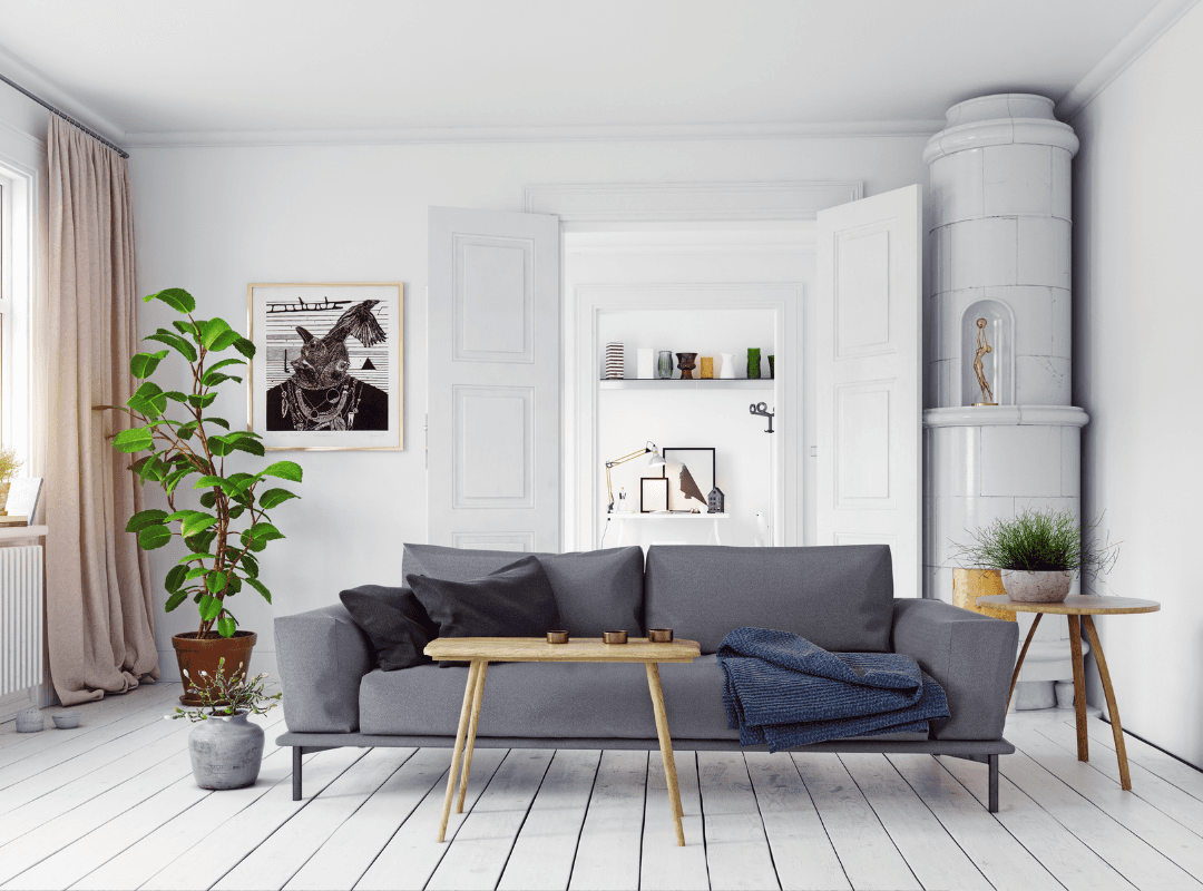 Living room with grey couch, light wooden tables, grey and white layered texture throughout.