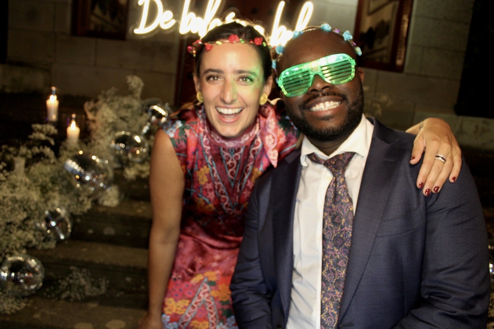 Close-up of two hands gently clasped, one wearing a sparkling engagement ring. The soft lighting and pastel nails evoke a sense of romance and intimacy.