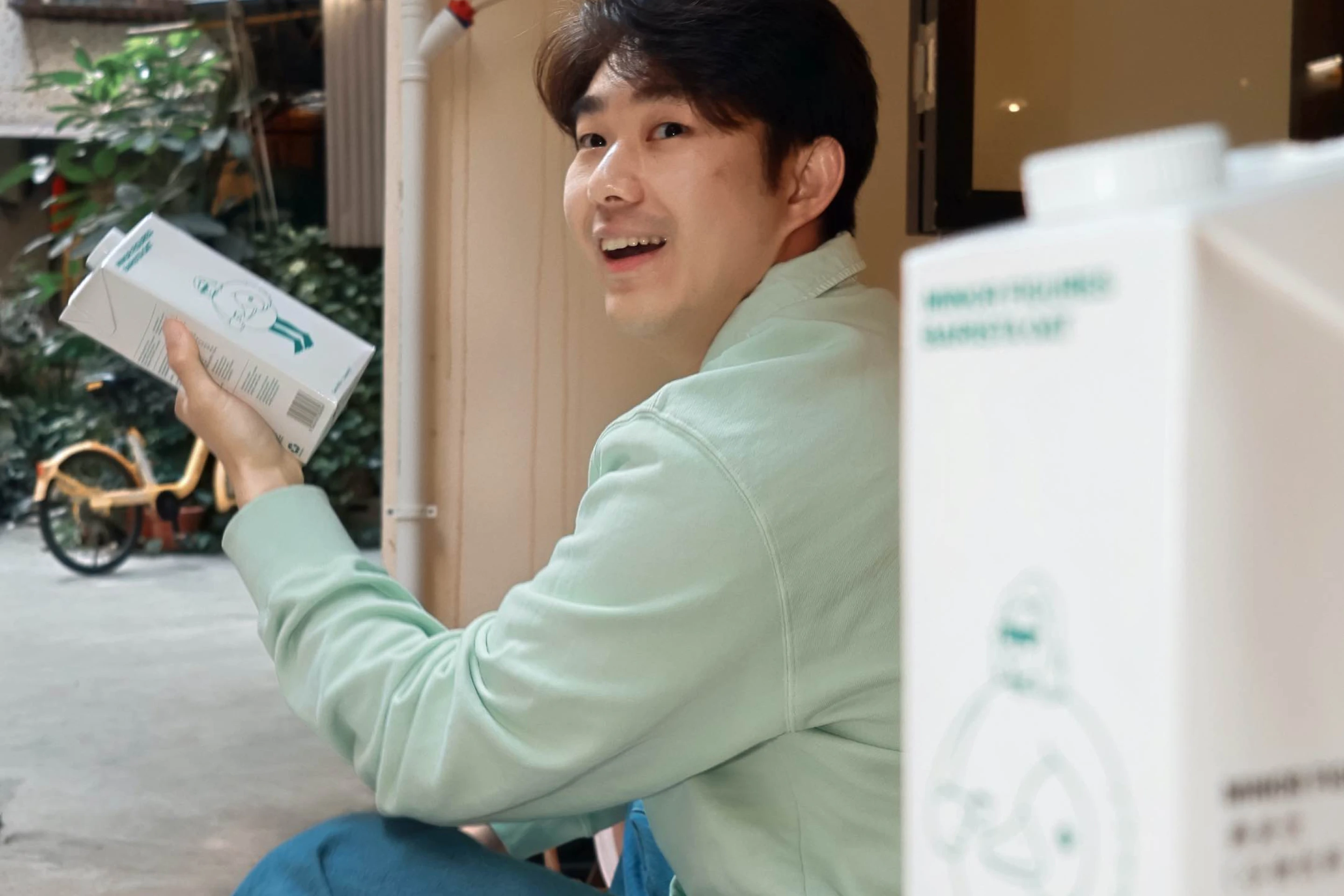 Chinese shopper holding Minor Figures non-dairy milk in Shanghai