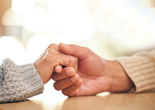 A close up image of two hands holding 