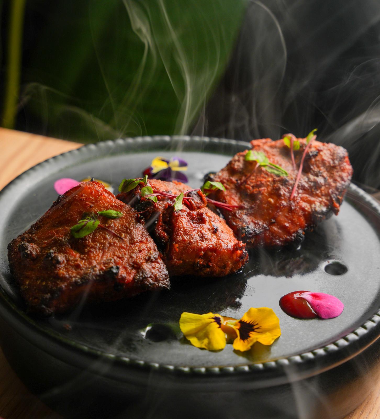 Char-grilled salmon kebab with Indian spices served at Dhoom Greektown Toronto