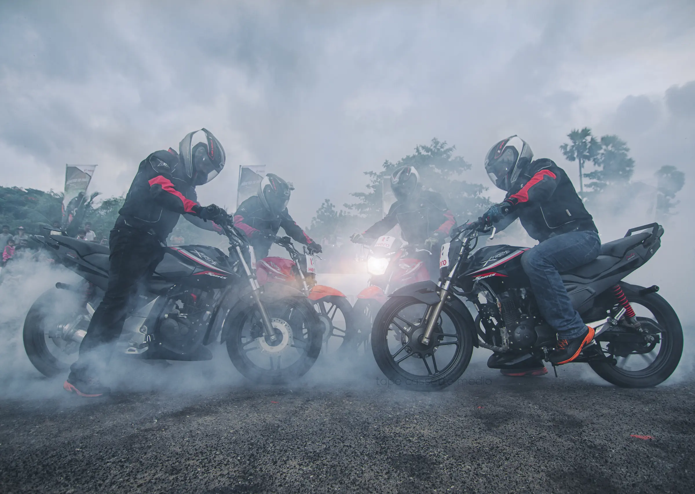 Motorcyclists ride through foggy skies amid vehicles and helmets, creating a scene ideal for brand advertising