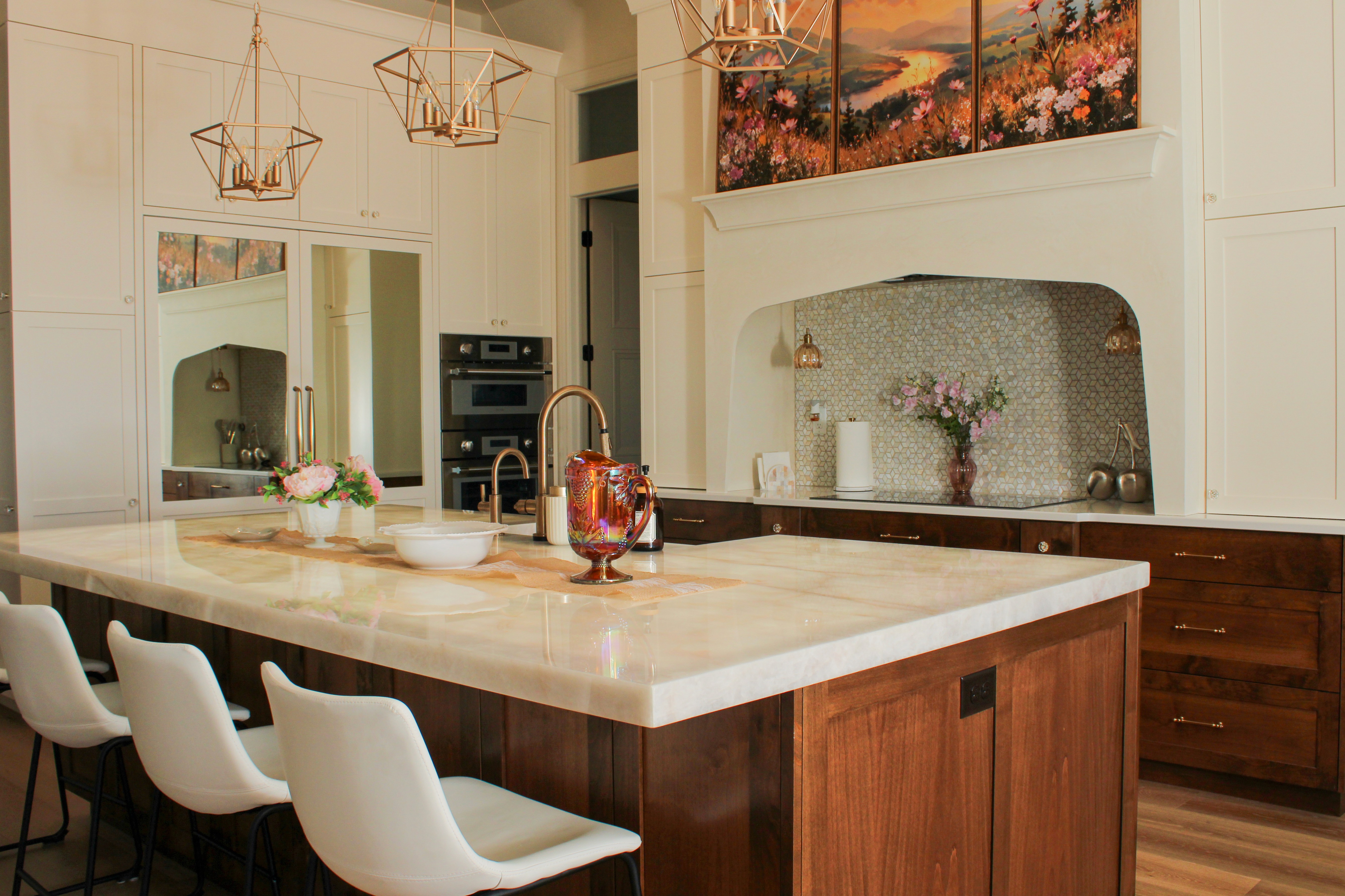 Custom kitchen with two toned cabinetry, a custom designed hood, and a light up kitchen insland in a St. George, Utah custom home.