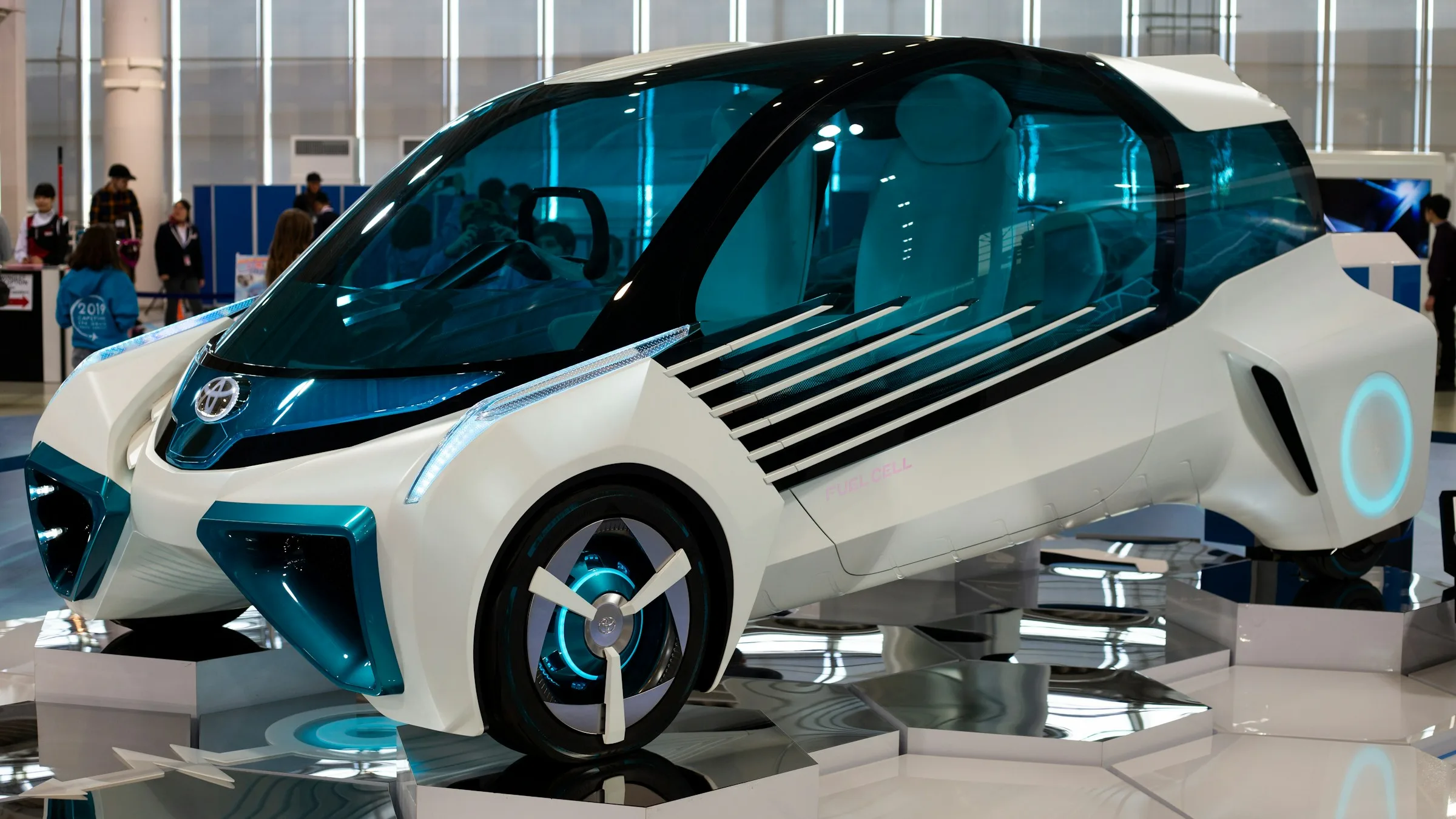 White hydrogen fuel cell concept car on display at an auto show