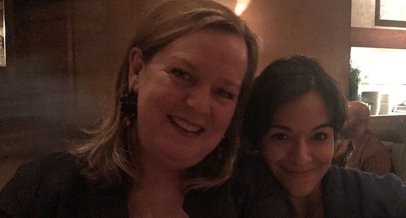 A photo of two women in a room.