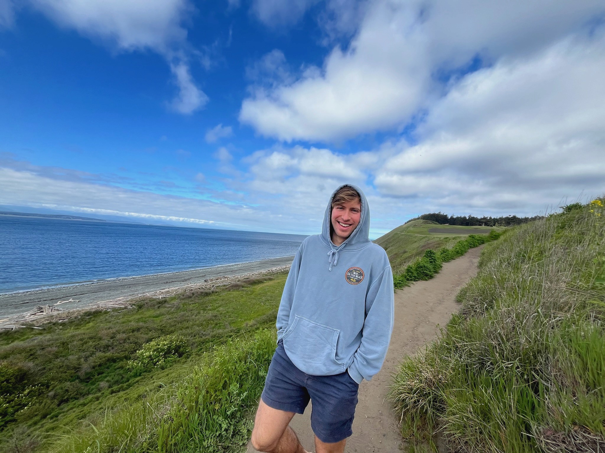 An image of me standing on a hill leading down to the ocean.