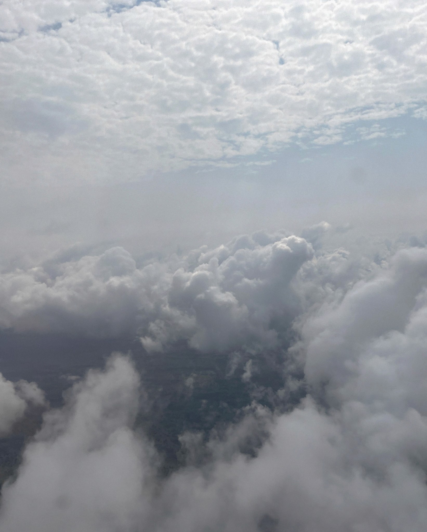 Sunlight shines through cloud filled sky.