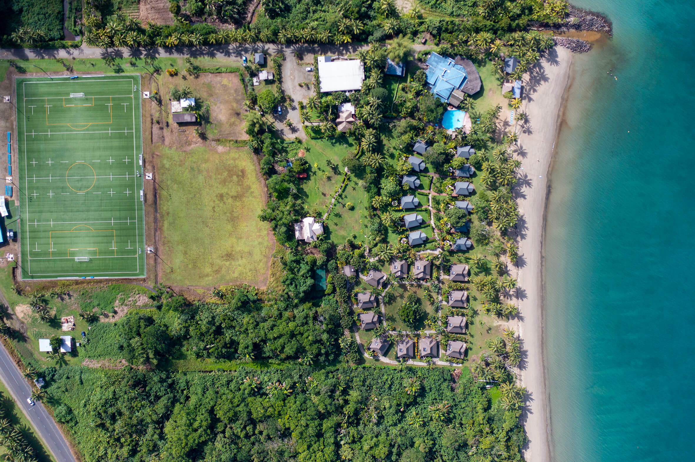 Aeriel view of Uprising beach resort, from the top down, whole resort is seen pictured along the beachside in Fiji