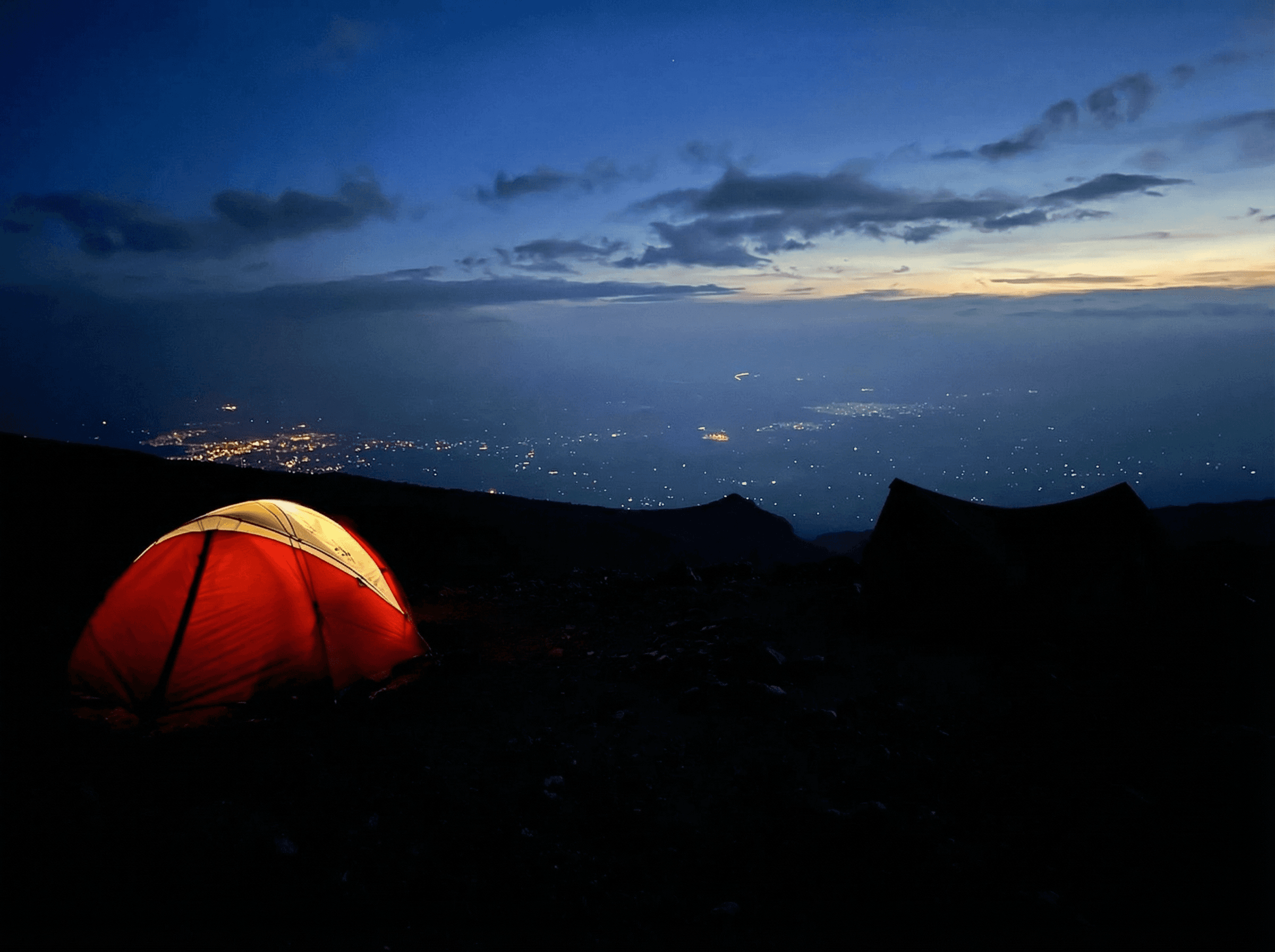 Majestic sandstone formations in AlUla glowing under the afternoon sun, showcasing the desert’s timeless beauty.