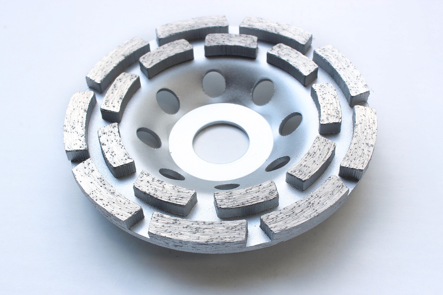 Silver Diamond grinding cup wheel with large segments for efficient grinding of concrete and stone surfaces.