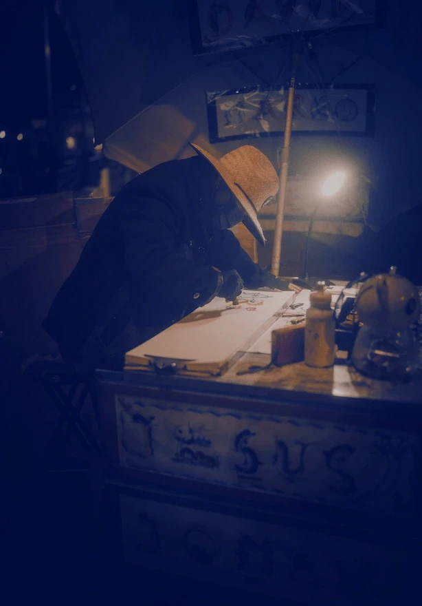 Creative person painting at a table by lamplight