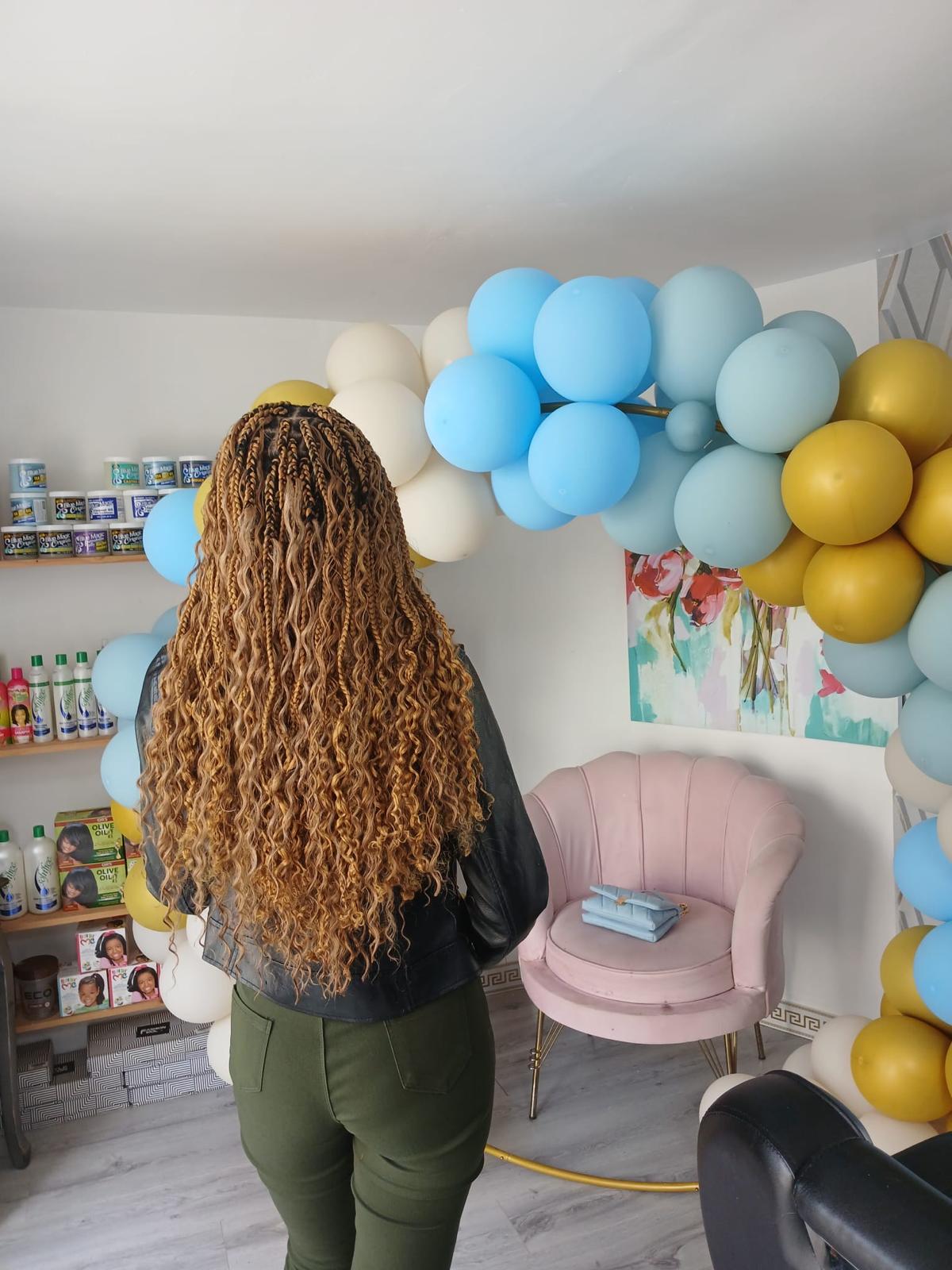 Long curly honey-blonde wig styled for a client