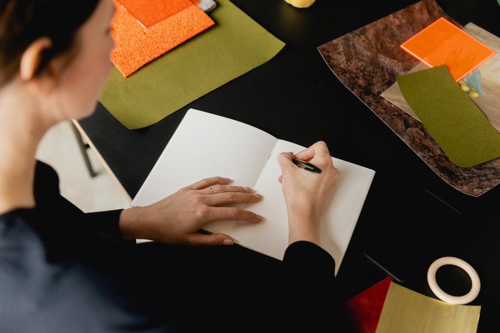 Close up of a person writing in a notebook