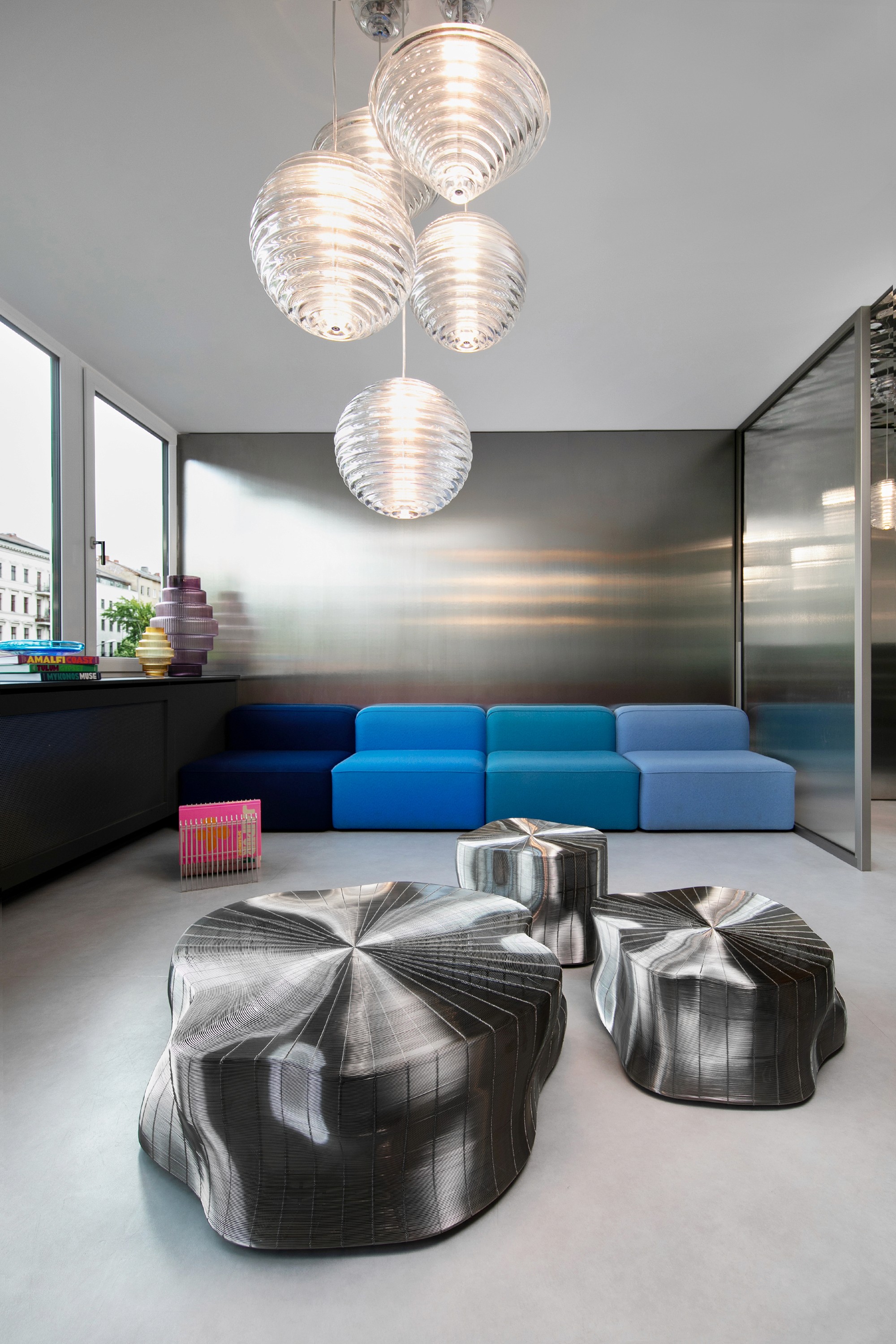 Close-up of hands holding a small glass bottle with a liquid skincare product, against a soft, blurred background