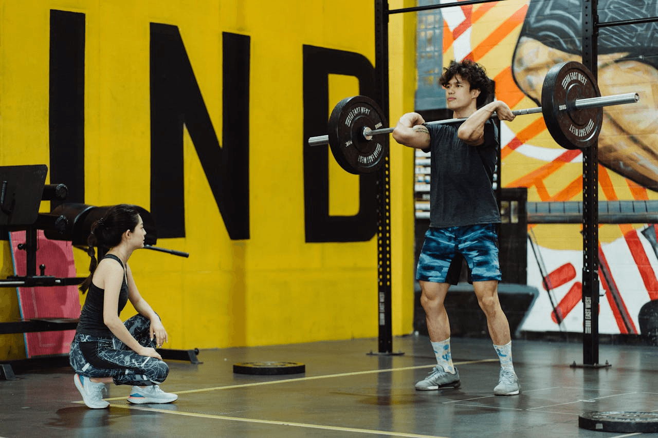 A Weightlifter Holding a Barbell on His Shoulders 