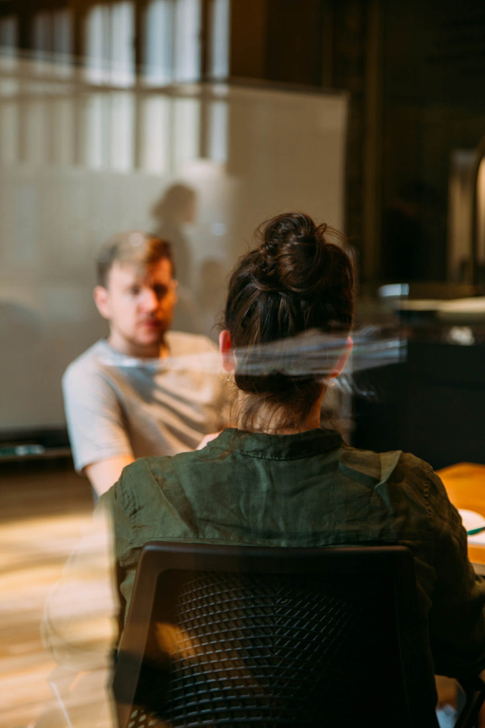 person sitting in a chair in front of a man