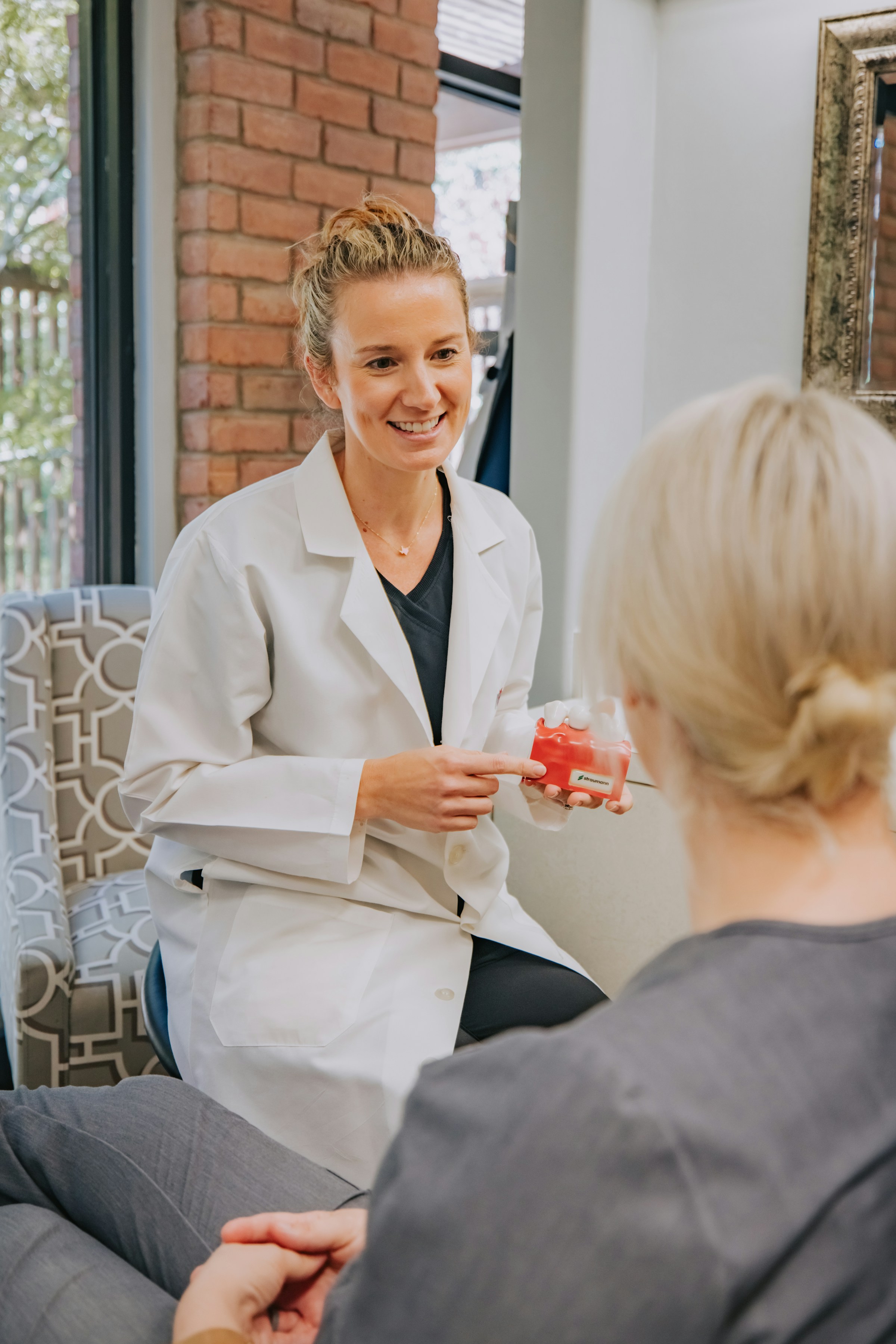 A dentist at Morrow Dental Group explaining a treatment model to a patient