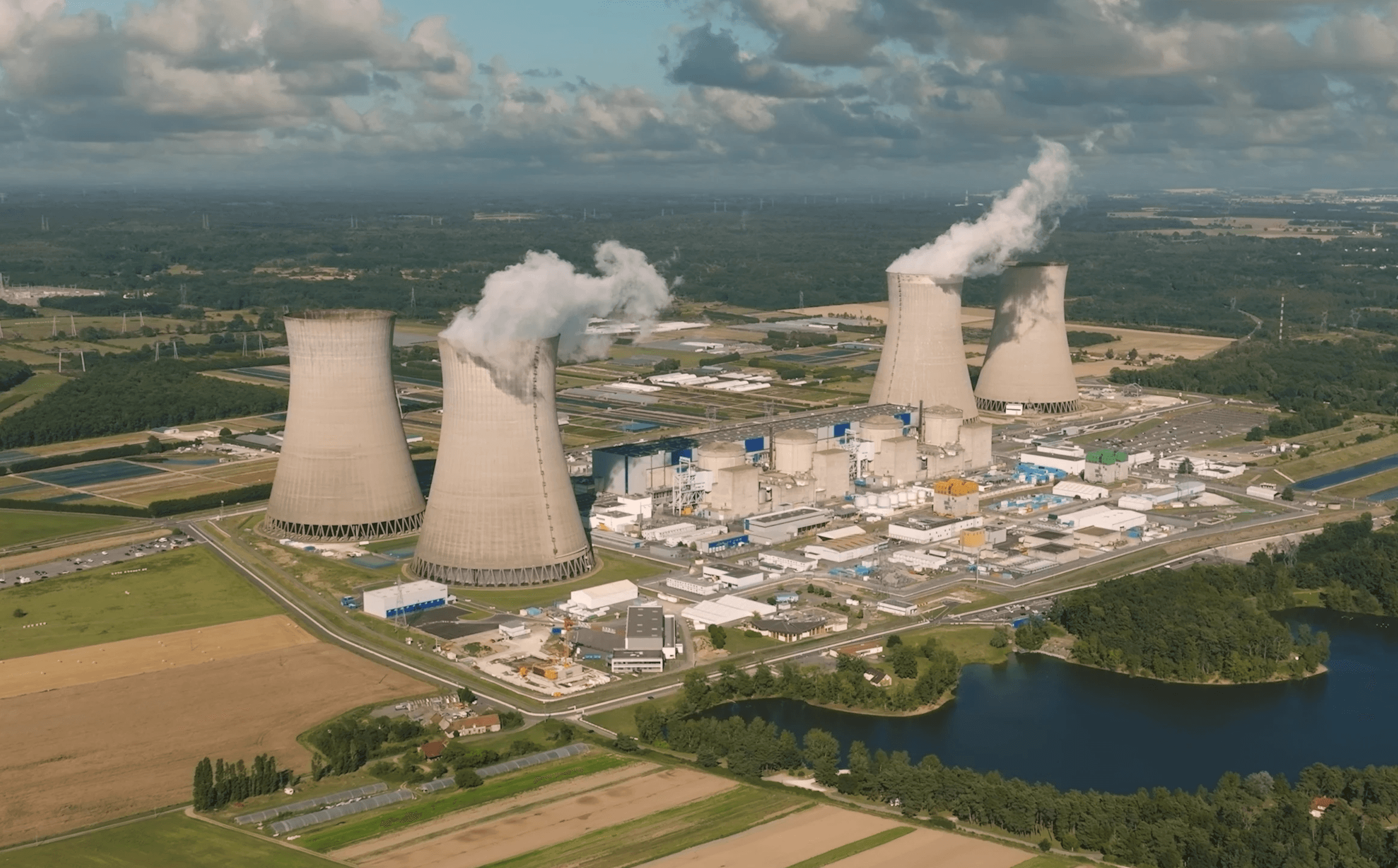 Nuclear power station with containment domes and cooling towers