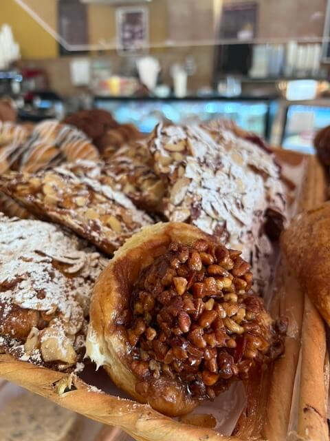 An assortment of pastries and danishes on a board.