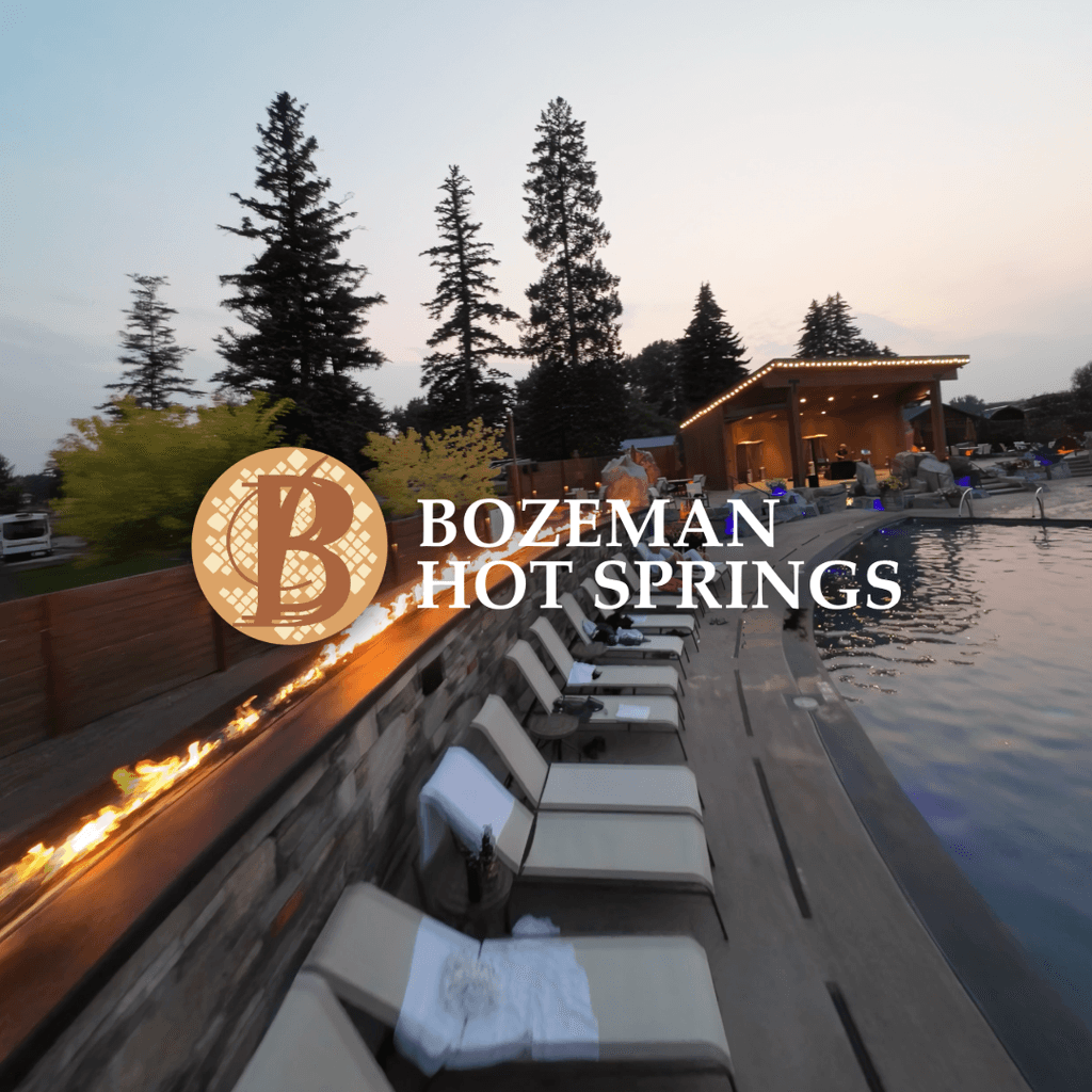 Evening aerial shot of Bozeman Hot Springs outdoor pools and lounge area