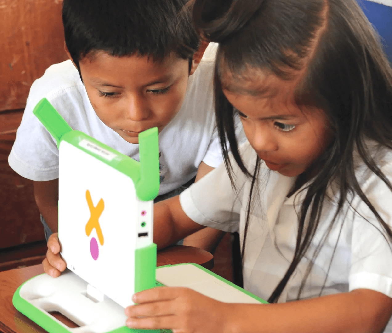 Two children using a laptop.