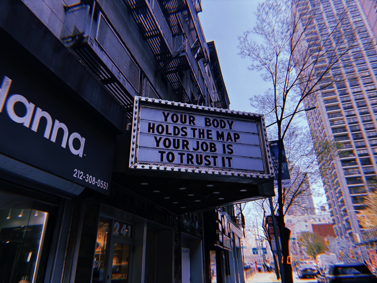 A marquee reading Your body holds the map / Your job is to trust it Photograph by Pranjali Shah.