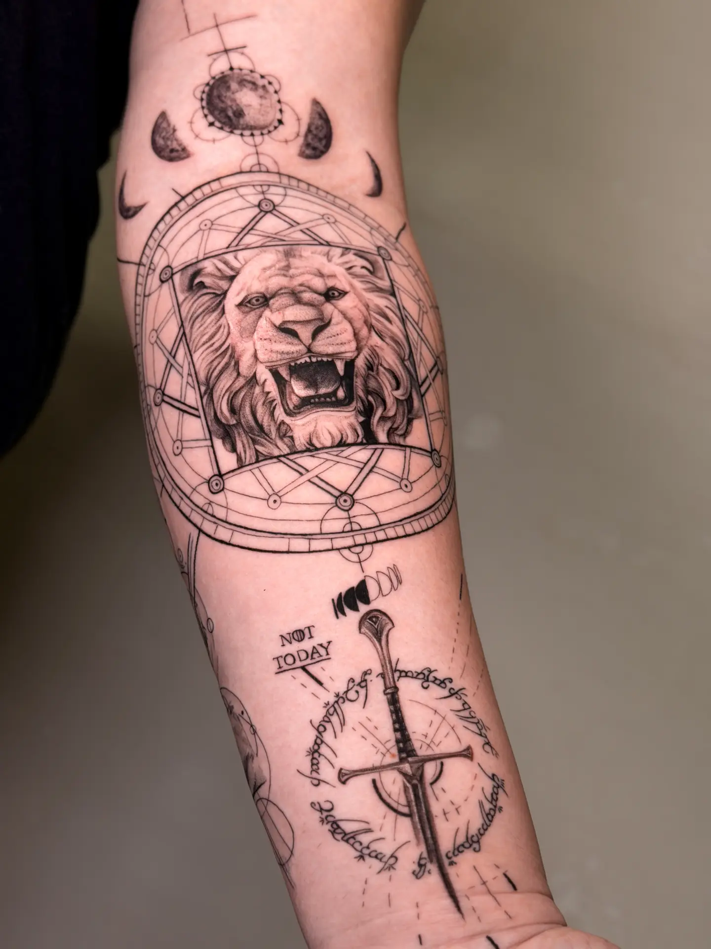 Close-up of the tattooing process revealing detailed micro-realism lion shading while applying soothing aftercare balm in a sterile studio environment.