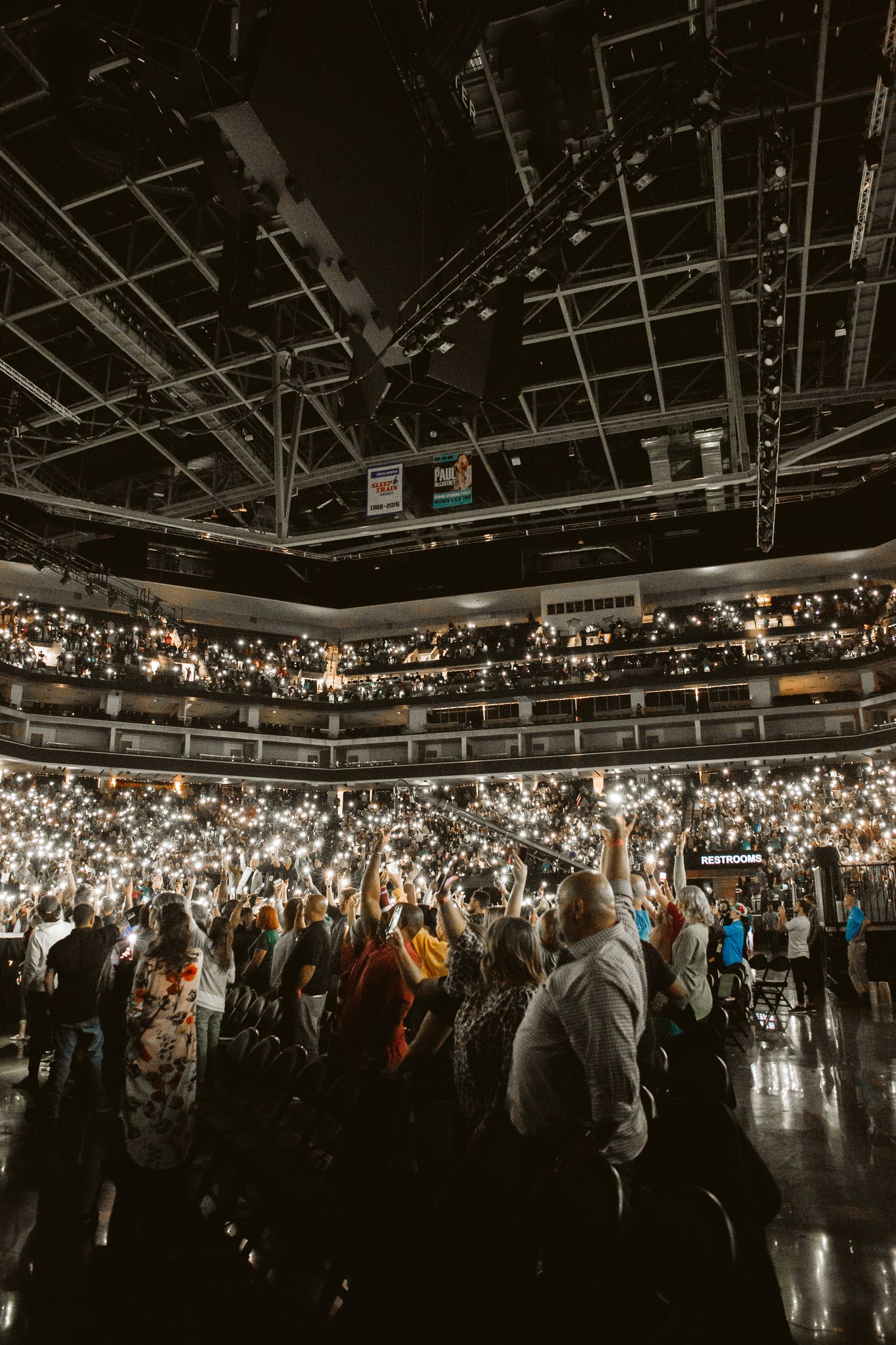person sitting on grass and using phone