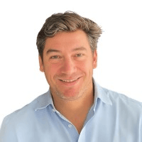 woman in black crew neck t-shirt wearing brown framed eyeglasses standing on rocky shore during