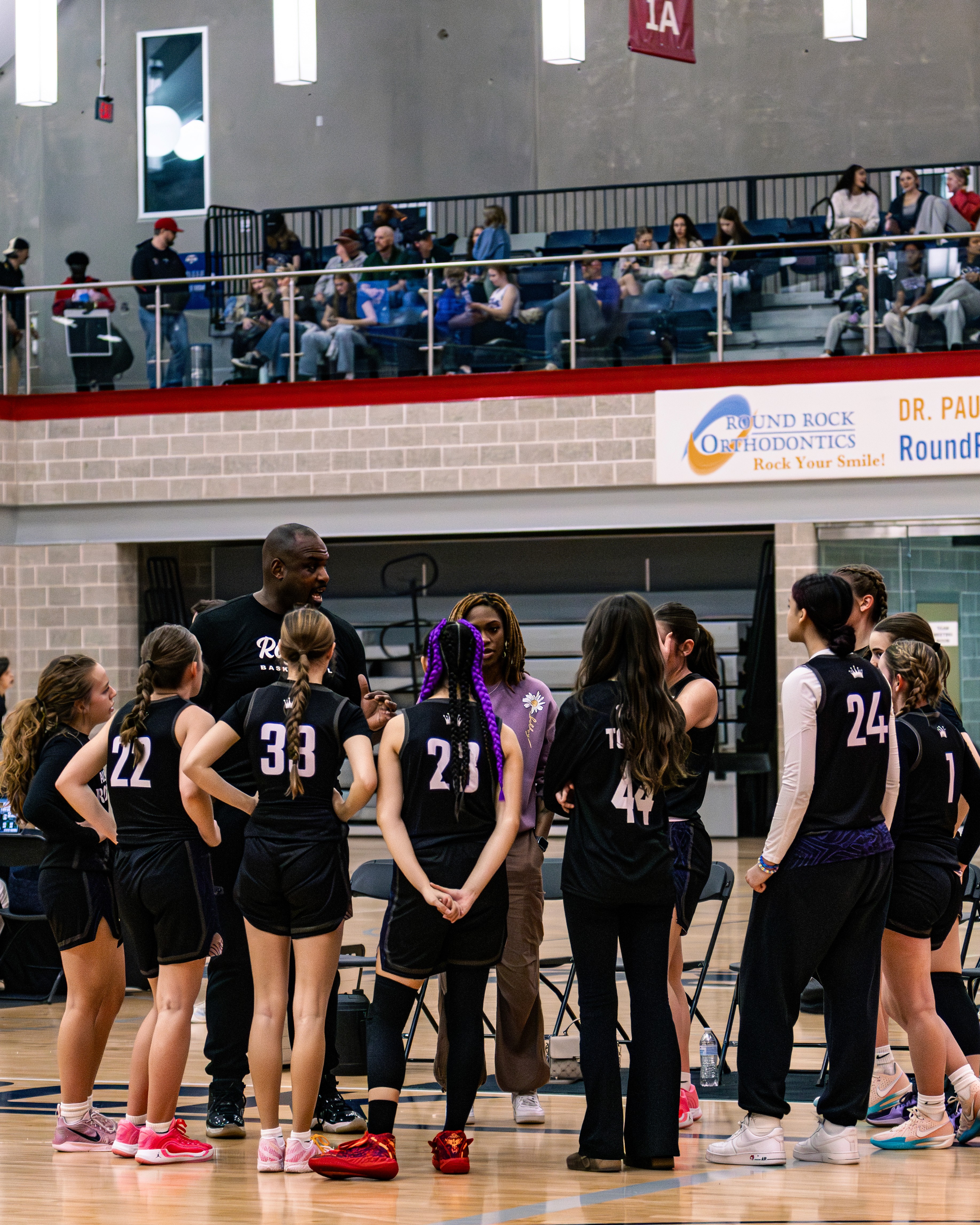 Rachel, personal trainer, looking to the side confidently in a fitness studio