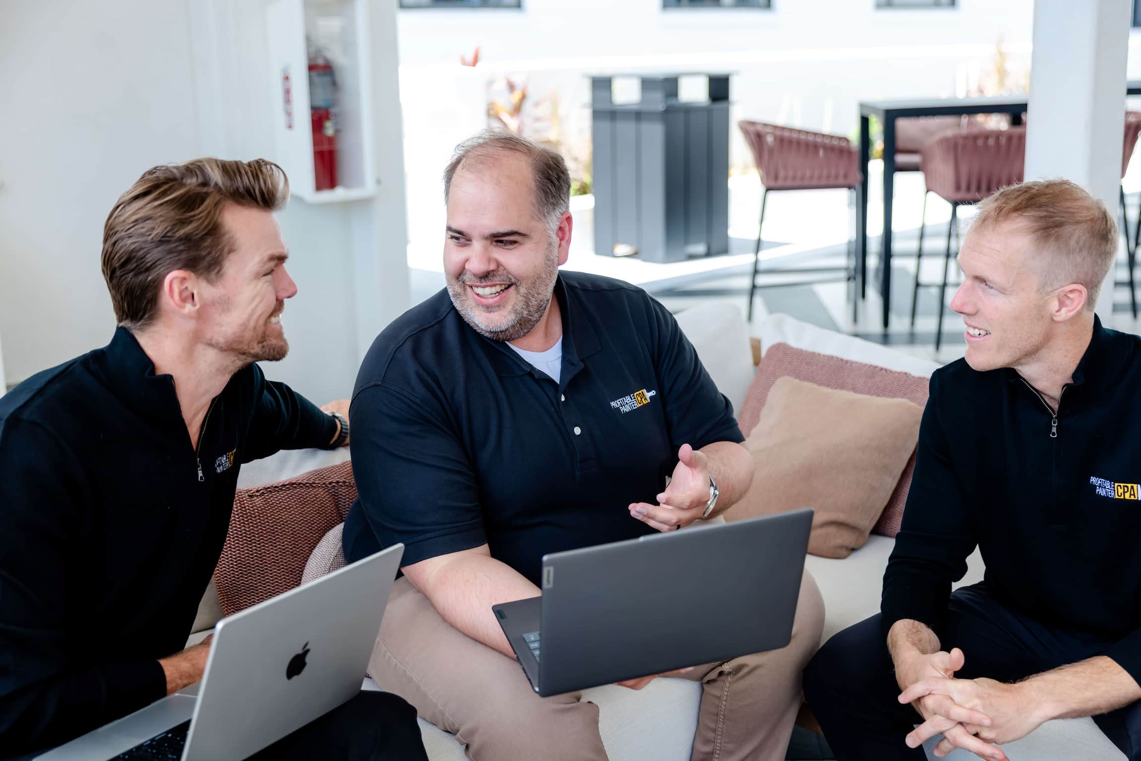 Image of Proftiable Painter staff smiling on sofa.