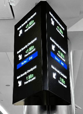 A photo of 2 screens showing real time security queue updates