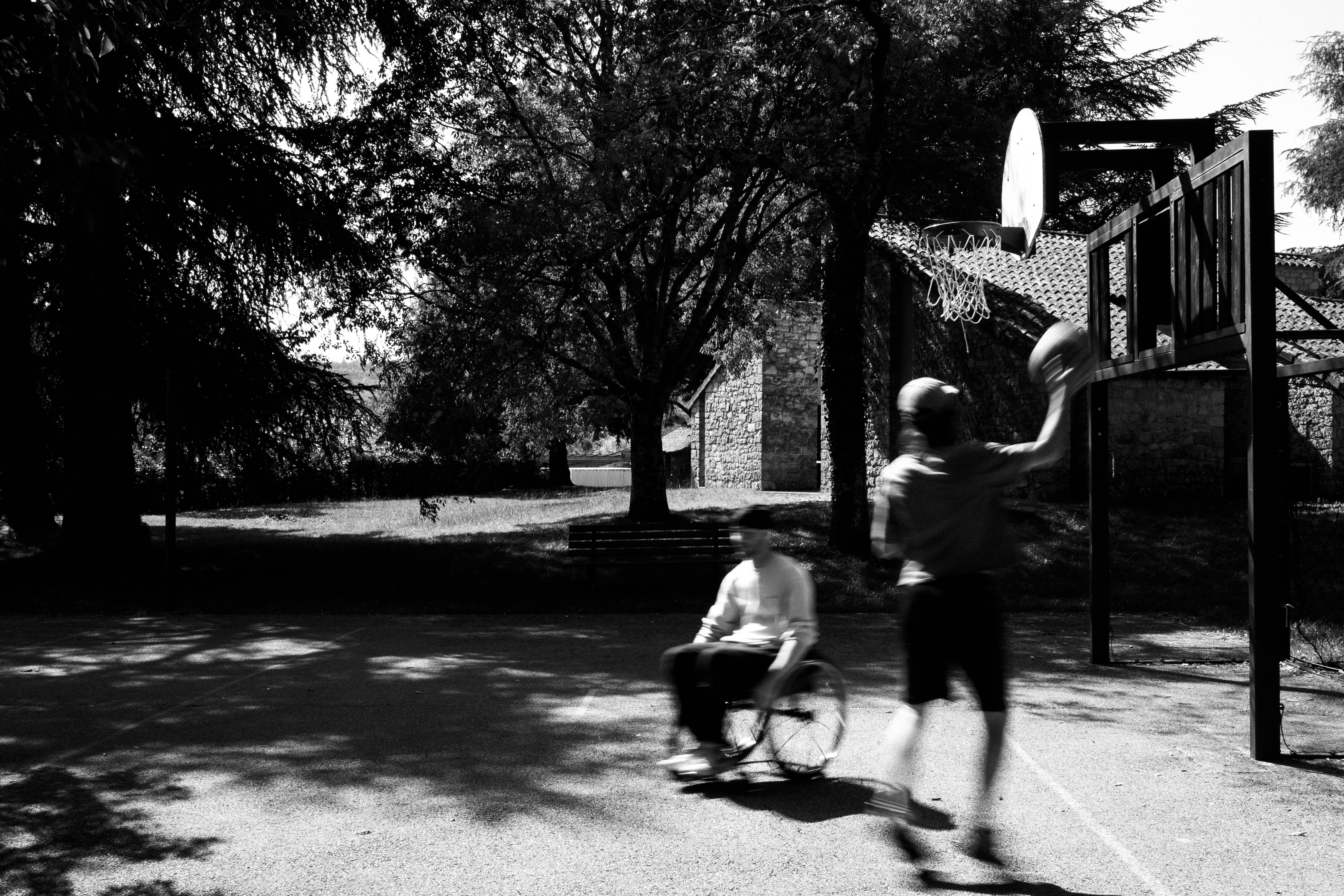 Silhouettes of cyclists and walkers against a misty bridge