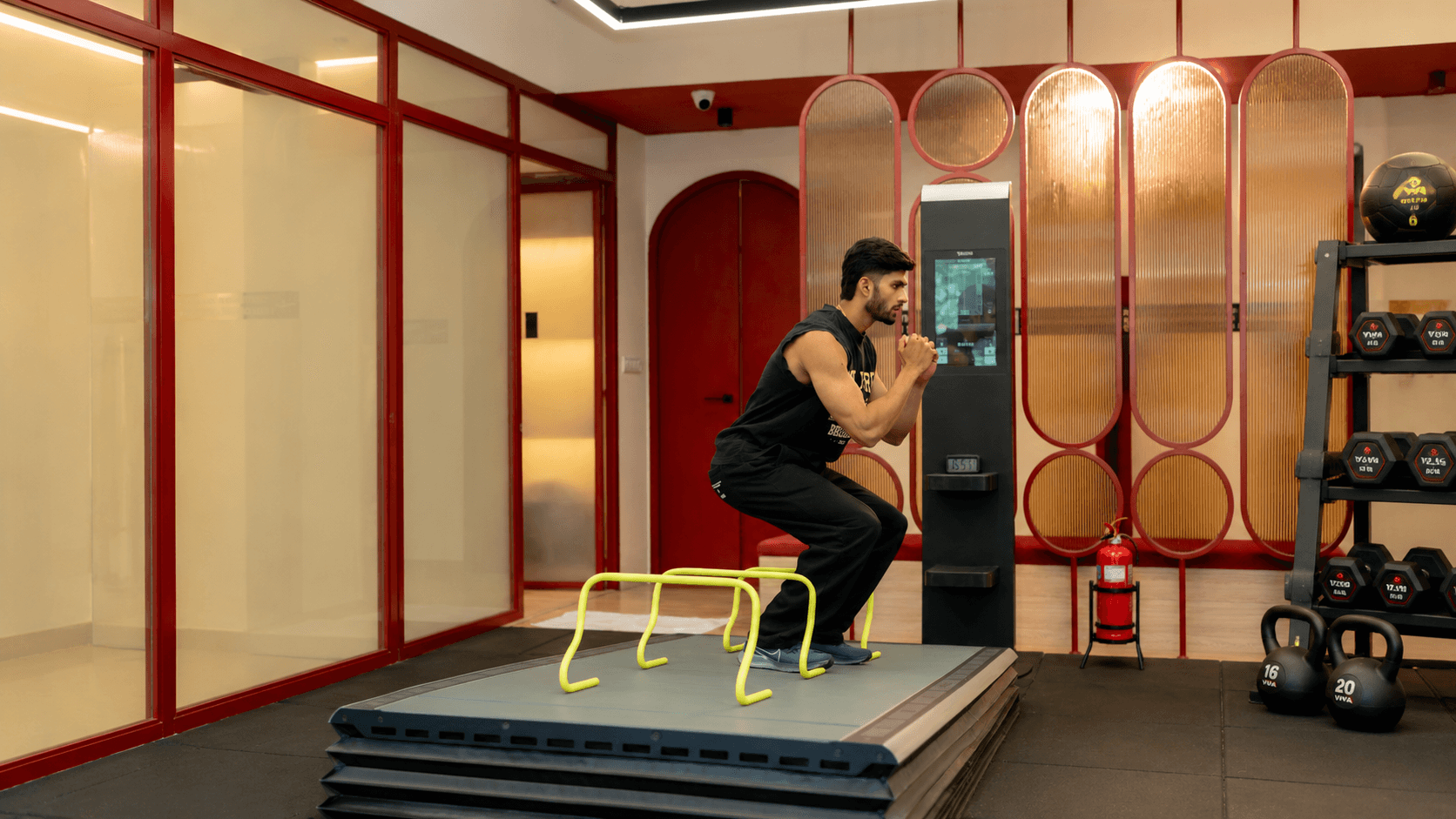 Man performing hurdle drills during an athletic development training session at Ember & Ice Health performance studio.