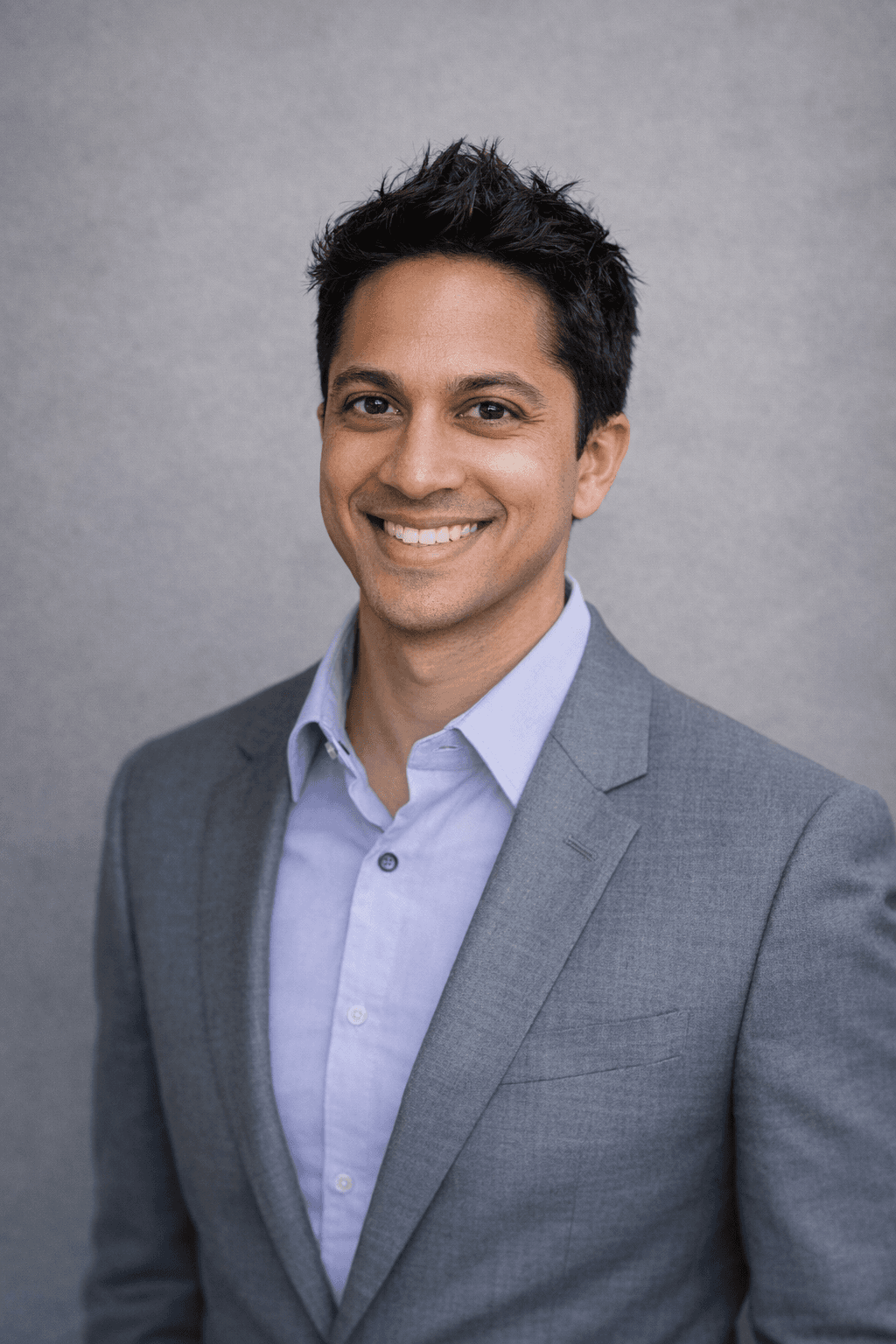 Black and white portrait of a smiling person with curly hair