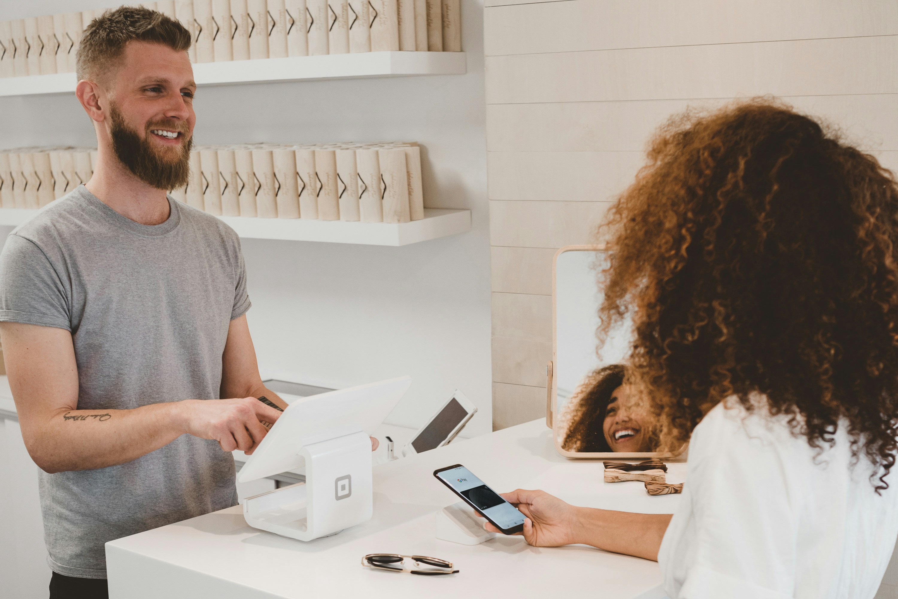 Cashier selling something over the counter