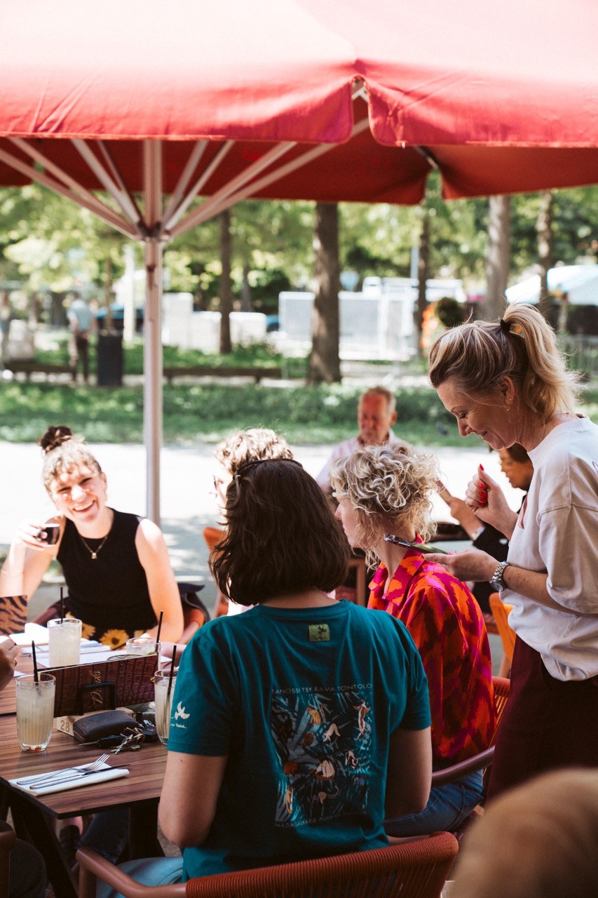 waiter at a terrace helping guests