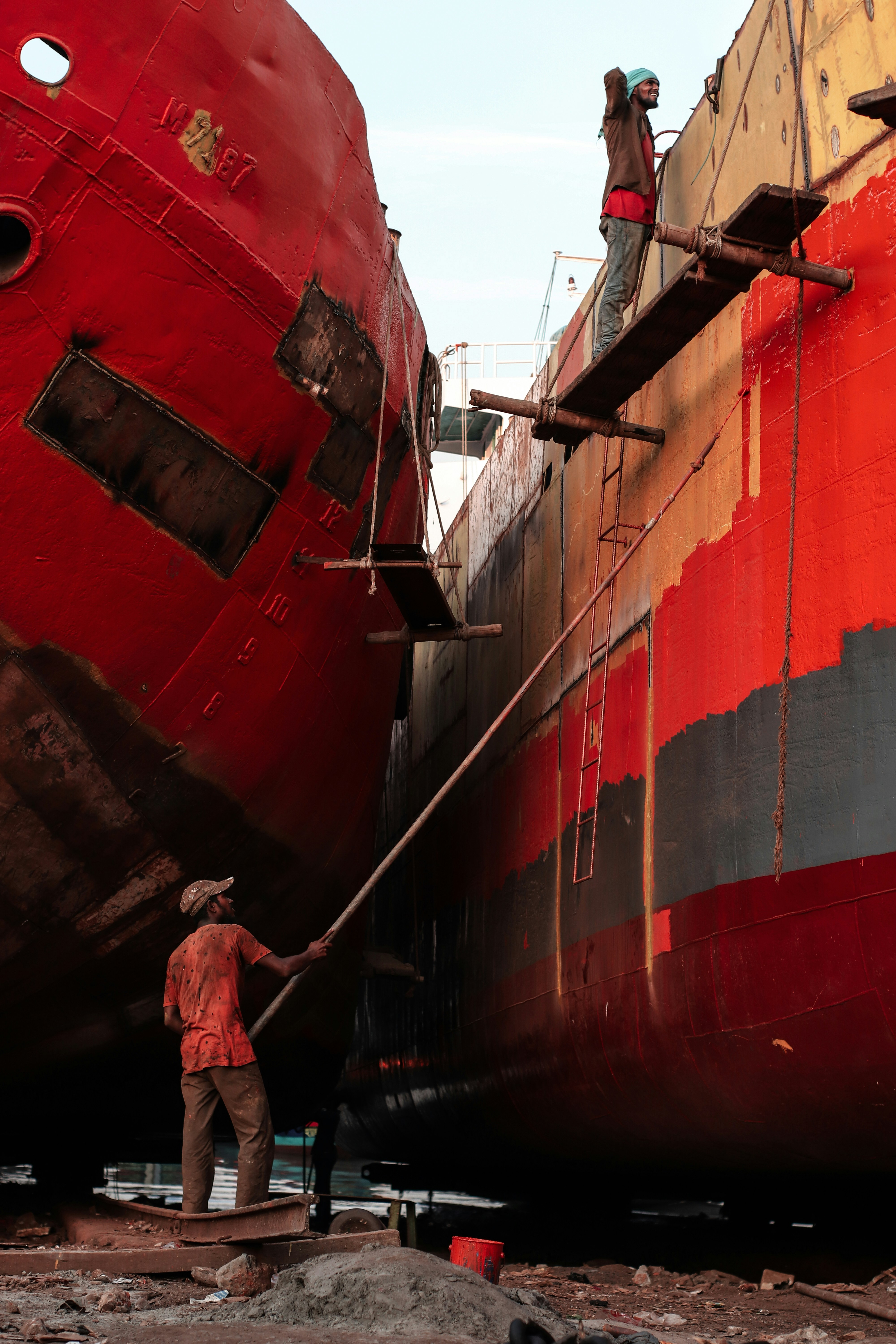 two men are working on a large ship