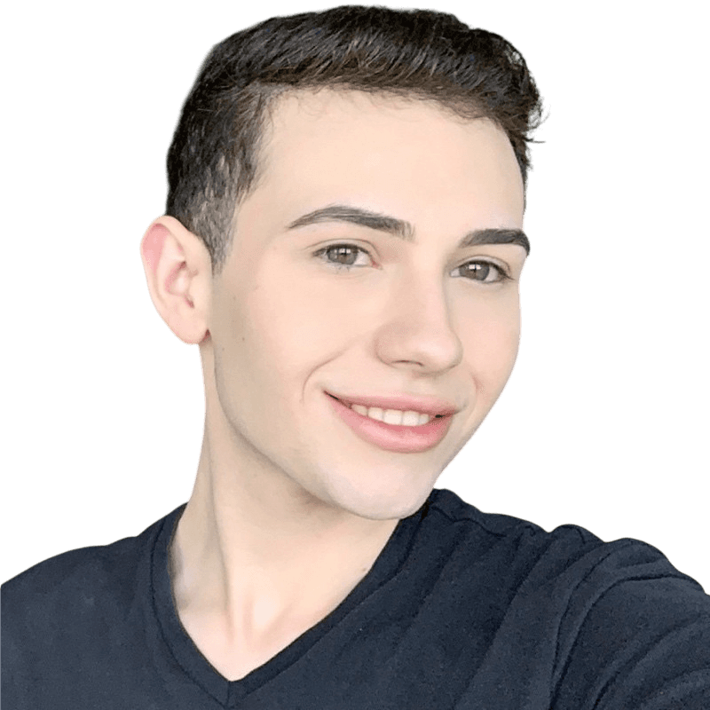 A thoughtful young person with dark hair gazes to the side, captured in soft black and white lighting.