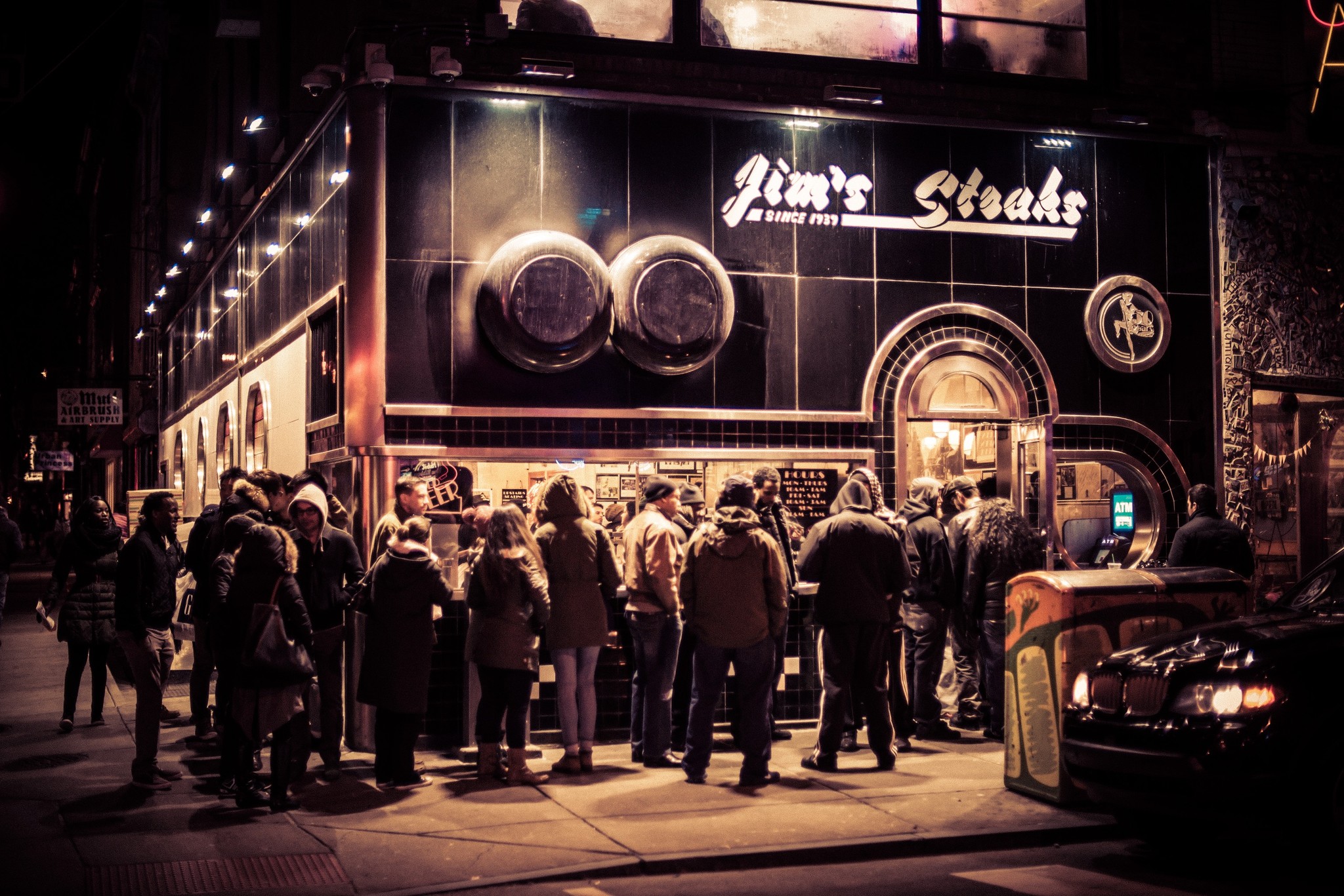 a line of people outside of Jim's Steaks in Philadelphia, PA