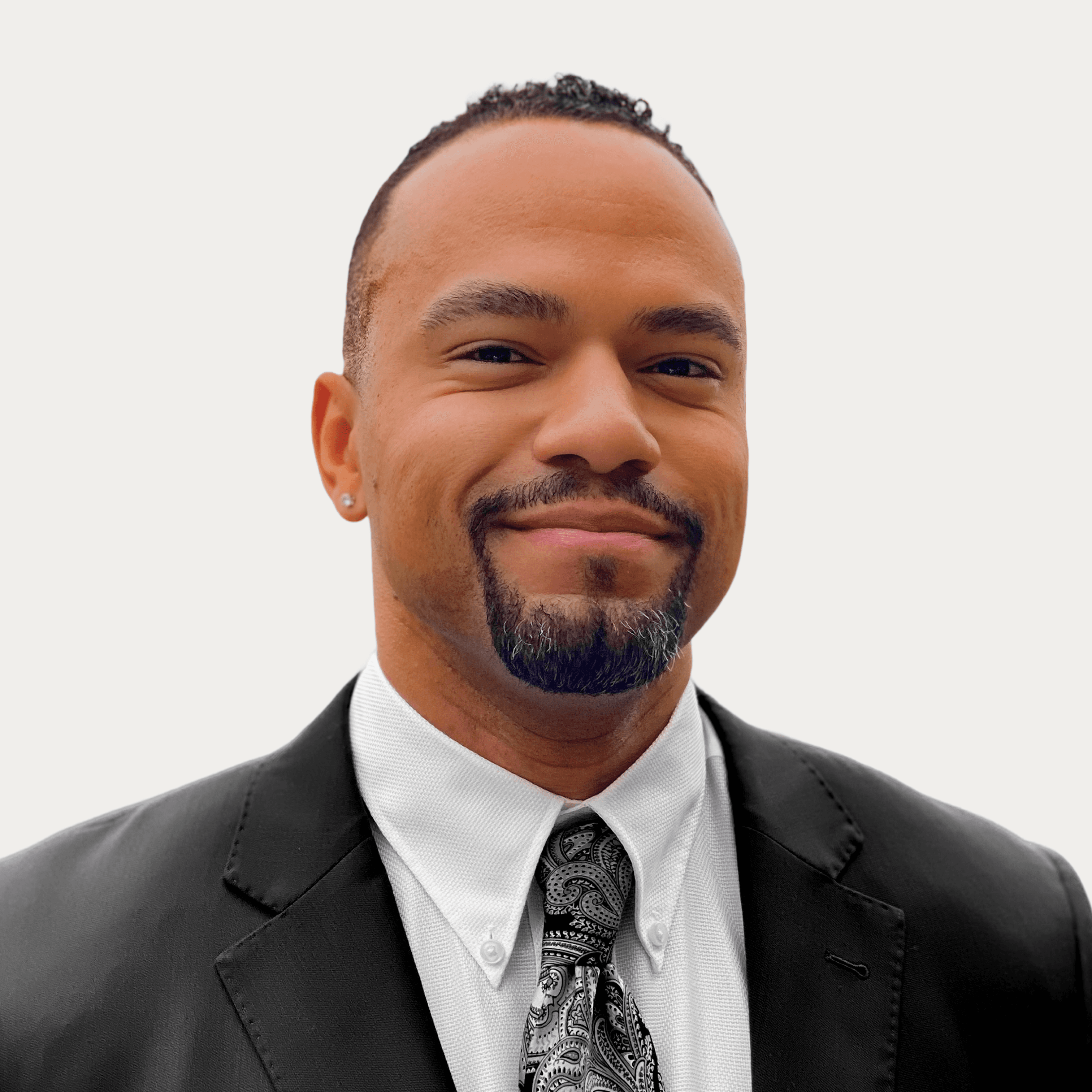 A thoughtful young person with dark hair gazes to the side, captured in soft black and white lighting.